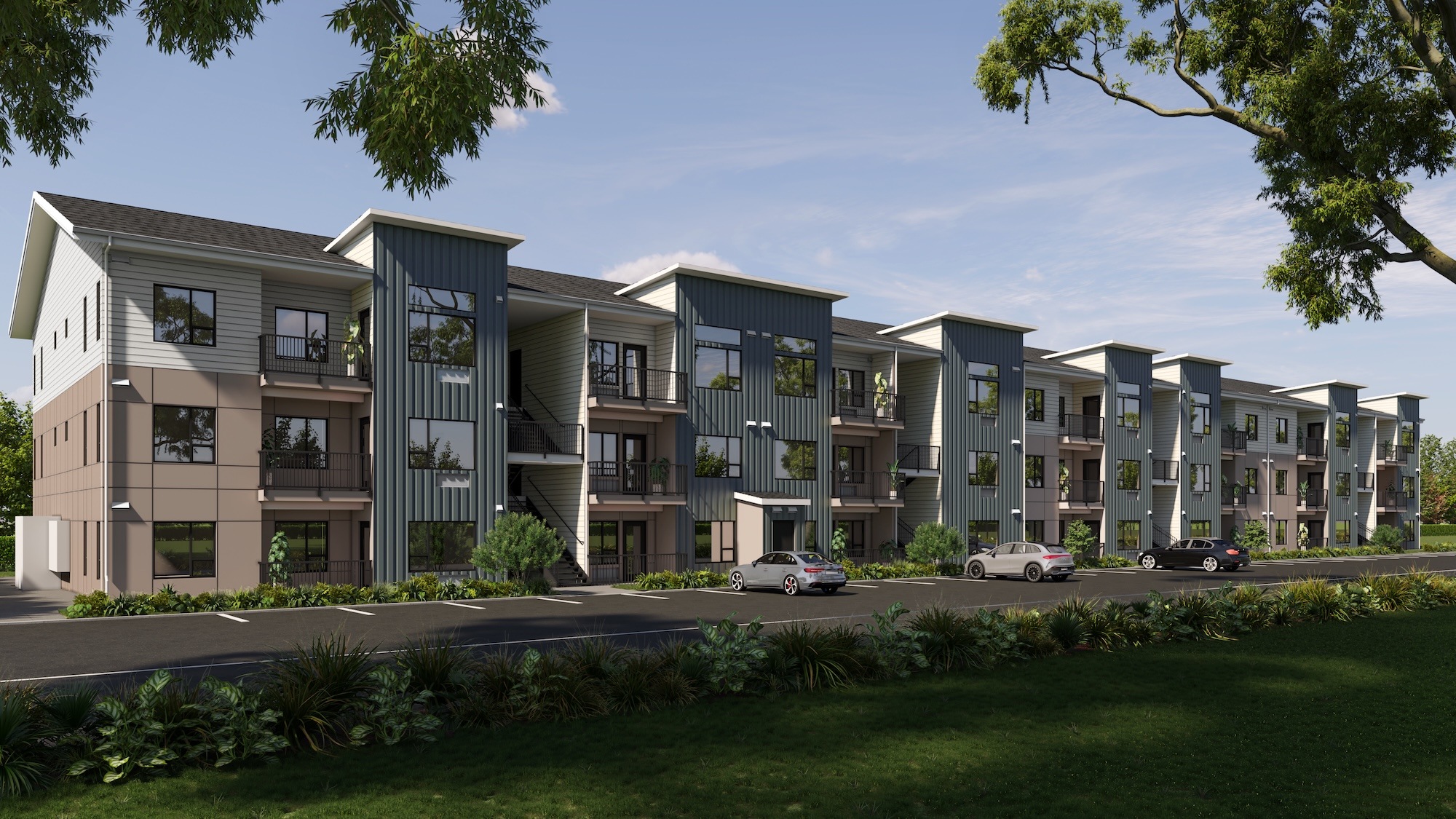 A modern apartment complex with multiple buildings and cars parked in front.